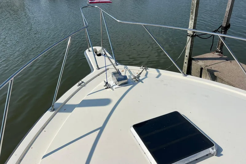 Slide: The Image of Bow of 1989 Egg Harbor 33 Convertible boat with anchor and railing. - 16