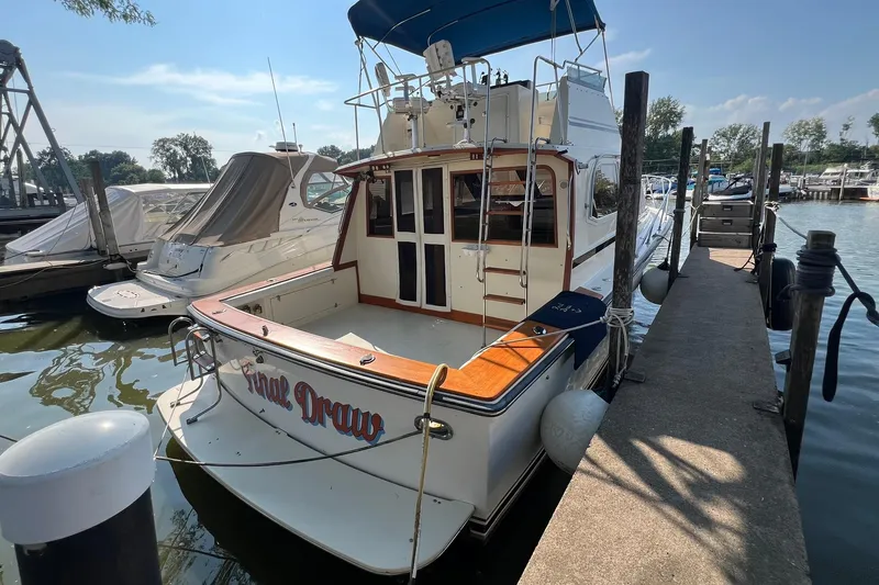 Slide: The Image of 1989 Egg Harbor 33 Convertible boat docked at marina, rear view. - 17