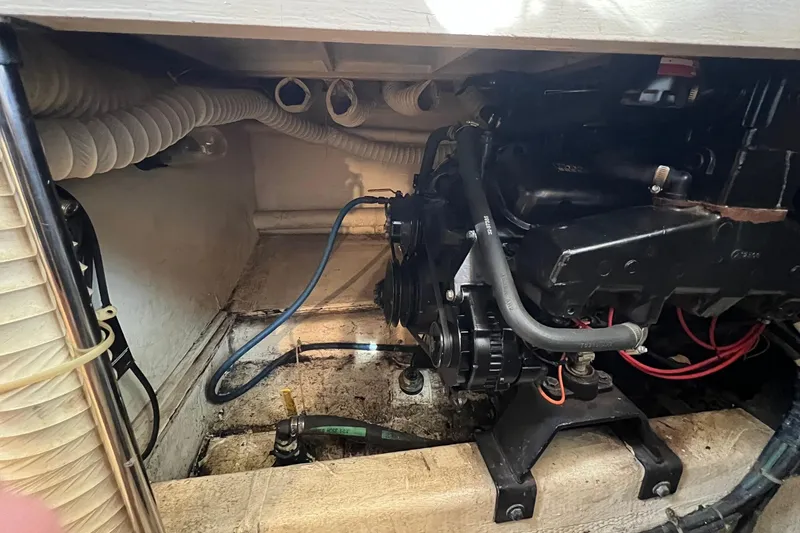Slide: The Image of Engine compartment of a 1989 Egg Harbor 33 Convertible boat, showing mechanical components. - 22