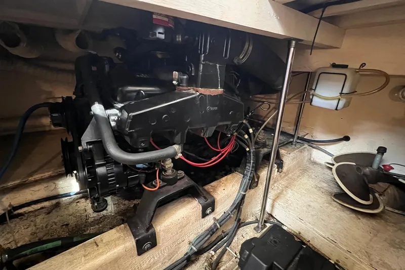 Slide: The Image of Engine compartment of a 1989 Egg Harbor 33 Convertible boat, showcasing mechanical components. - 23