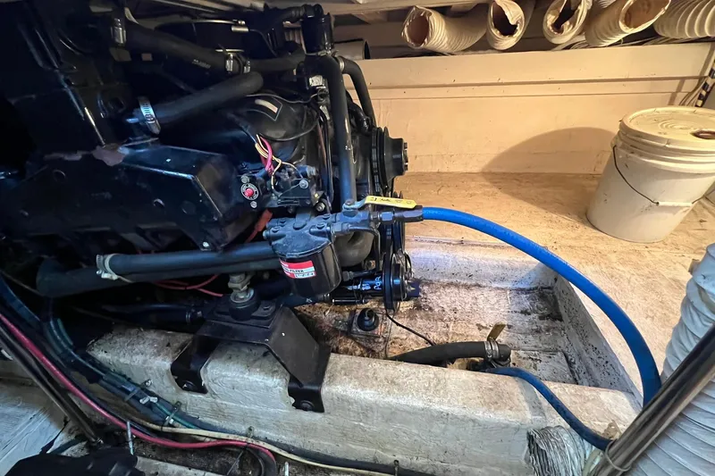 Slide: The Image of Engine room of 1989 Egg Harbor 33 Convertible boat, featuring mechanical components and hoses. - 26