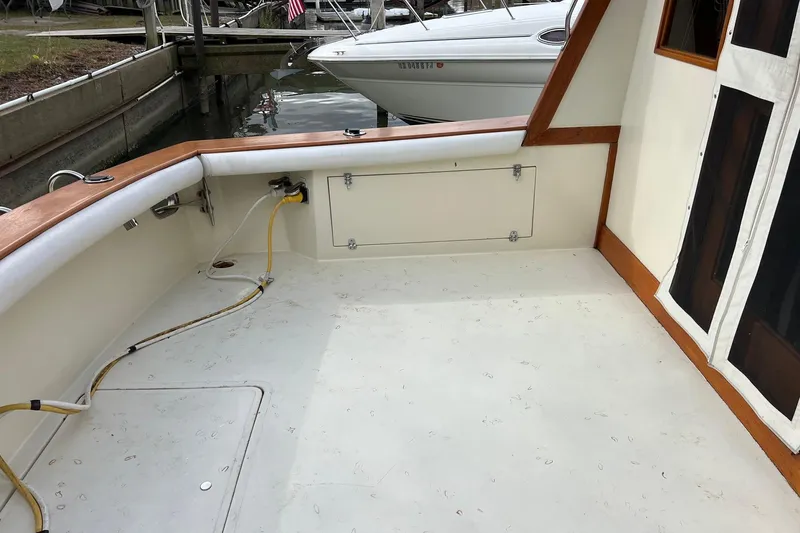 Slide: The Image of 1989 Egg Harbor 33 Convertible boat deck with wood trim and docked in marina. - 27