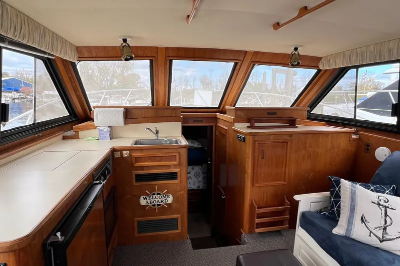 Slide: The Image of Interior of 1989 Egg Harbor 33 Convertible yacht with wood finish and nautical decor. - 28