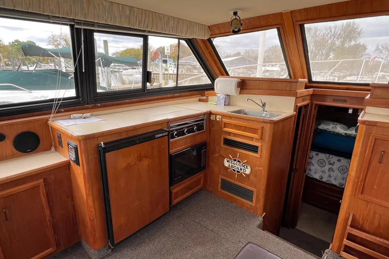 Slide: The Image of 1989 Egg Harbor 33 Convertible yacht interior with kitchen, sink, and cozy cabin. - 29