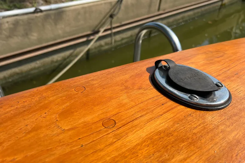 Slide: The Image of 1989 Egg Harbor 33 Convertible boat deck with chrome fitting and wooden finish. - 3