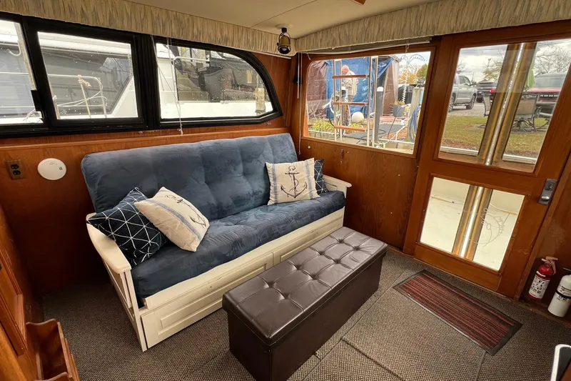 Slide: The Image of Interior of 1989 Egg Harbor 33 Convertible with blue sofa and nautical decor. - 32