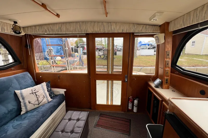 Slide: The Image of Interior of 1989 Egg Harbor 33 Convertible boat with nautical decor and wooden finishes. - 34