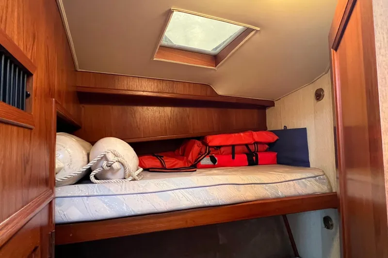 Slide: The Image of Cozy cabin interior of 1989 Egg Harbor 33 Convertible with life jackets and porthole. - 36