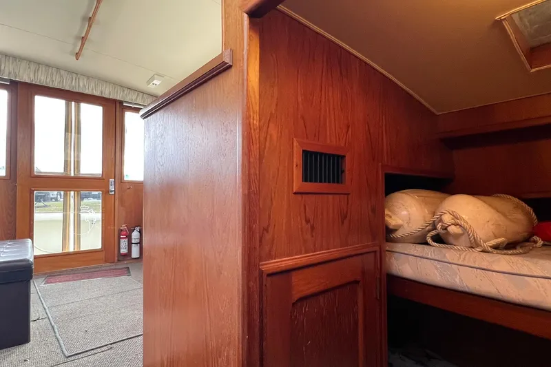 Slide: The Image of Interior of 1989 Egg Harbor 33 Convertible boat with wooden paneling and cozy cabin space. - 39