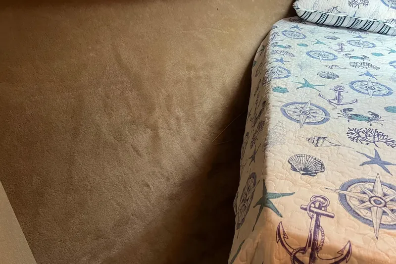 Slide: The Image of Nautical-themed bedding in 1989 Egg Harbor 33 Convertible cabin interior. - 45