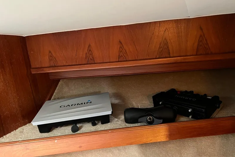 Slide: The Image of Garmin equipment inside 1989 Egg Harbor 33 Convertible boat with wooden interior. - 47