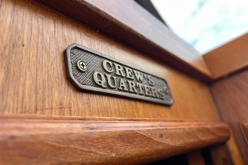Slide: The Image of Plaque reading "Crew's Quarters" on 1989 Egg Harbor 33 Convertible boat interior. - 48