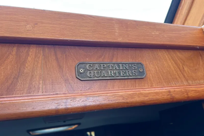 Slide: The Image of Plaque reading "Captain's Quarters" on 1989 Egg Harbor 33 Convertible boat interior. - 49