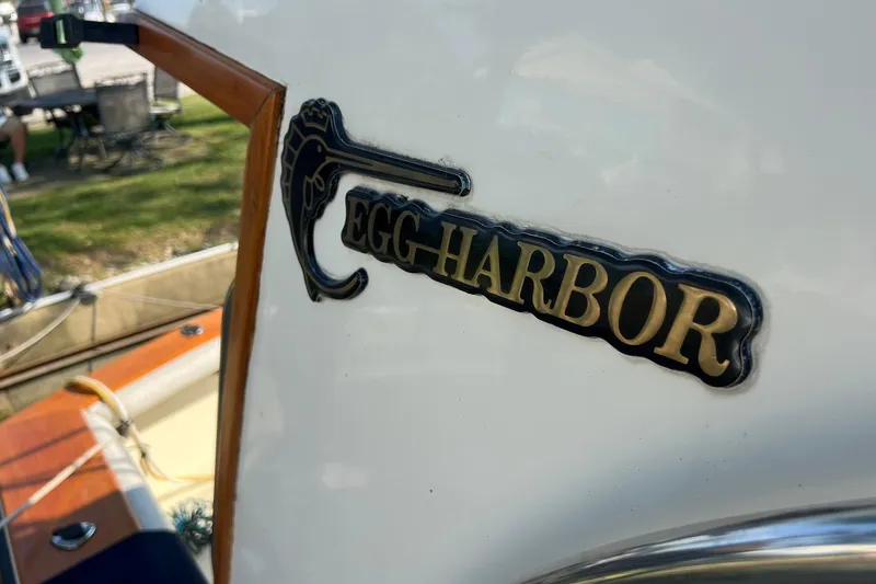 Slide: The Image of 1989 Egg Harbor 33 Convertible boat logo with gold lettering and decorative design. - 5