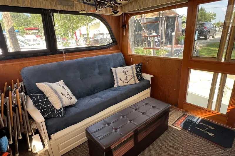 Slide: The Image of Interior of 1989 Egg Harbor 33 Convertible with blue sofa and nautical decor. - 6