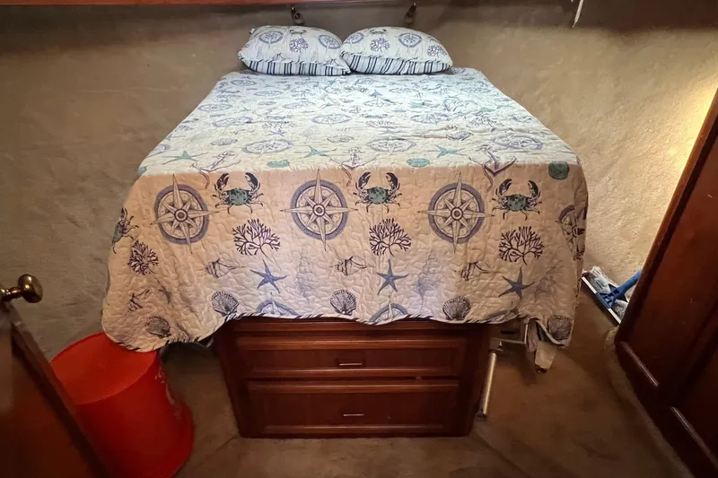 Slide: The Image of Cozy bedroom in 1989 Egg Harbor 33 Convertible with nautical-themed bedding. - 7