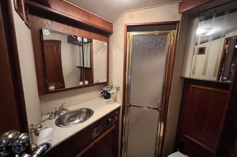 Slide: The Image of 1989 Egg Harbor 33 Convertible yacht bathroom with sink, mirror, and shower. - 9