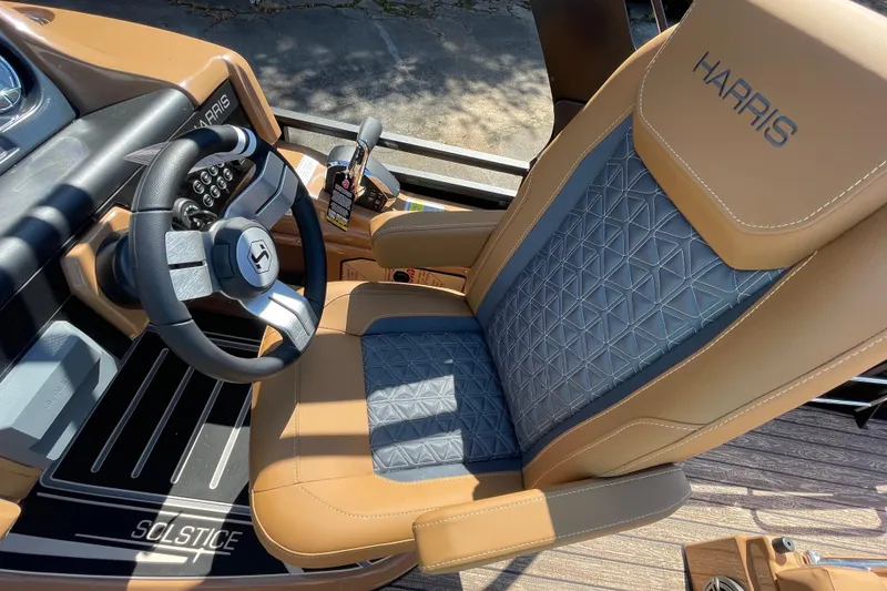 Slide: The Image of 2026 Harris Solstice 250 SLDH boat interior with luxury seating and modern steering wheel. - 11