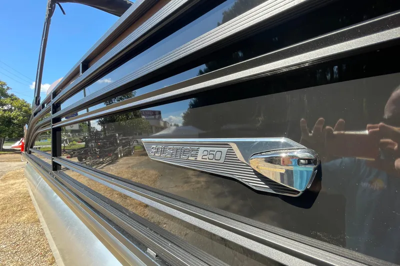 Slide: The Image of 2026 Harris Solstice 250 SLDH pontoon boat, sleek black exterior with chrome detailing. - 18