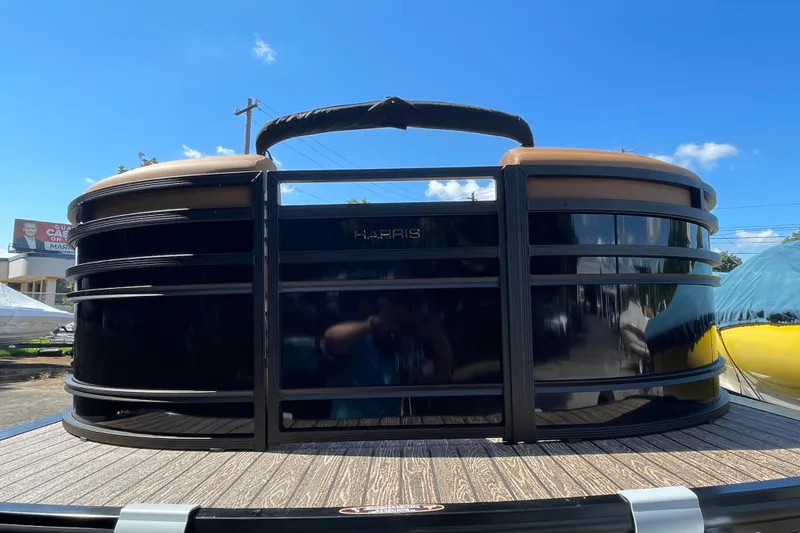 Slide: The Image of 2026 Harris Solstice 250 SLDH pontoon boat, sleek design under clear blue sky. - 19