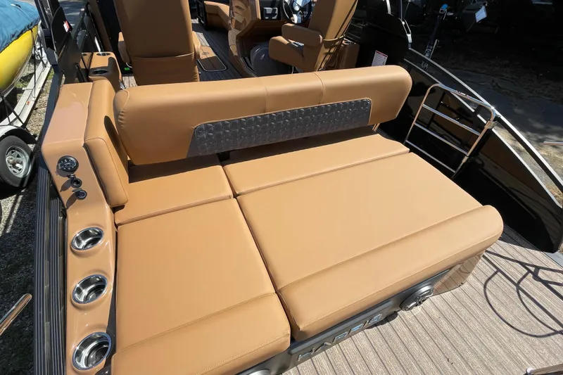Slide: The Image of Luxurious seating on 2026 Harris Solstice 250 SLDH boat with tan upholstery and cup holders. - 8