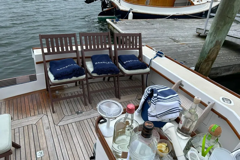 Slide: The Image of 1994 Little Harbor Express boat with wooden deck, chairs, and drinks near a dock. - 11