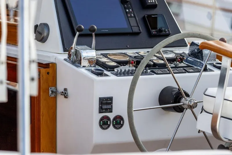 Slide: The Image of Control panel of a 1994 Little Harbor Express boat with steering wheel and navigation instruments. - 18