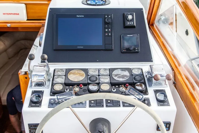 Slide: The Image of 1994 Little Harbor Express boat dashboard with navigation instruments and controls. - 19