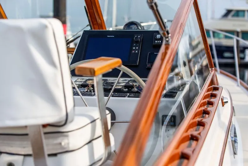 Slide: The Image of 1994 Little Harbor Express boat cockpit with wooden trim and modern navigation equipment. - 21