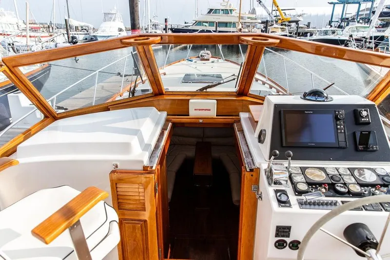 Slide: The Image of 1994 Little Harbor Express yacht cockpit with wooden accents and navigation equipment at marina. - 24