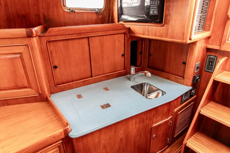 Slide: The Image of 1994 Little Harbor Express yacht interior with wooden cabinetry and compact sink area. - 30