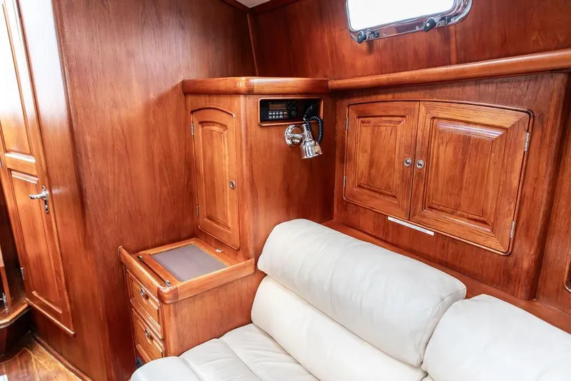 Slide: The Image of Luxurious 1994 Little Harbor Express yacht interior with wooden cabinetry and beige leather seating. - 32