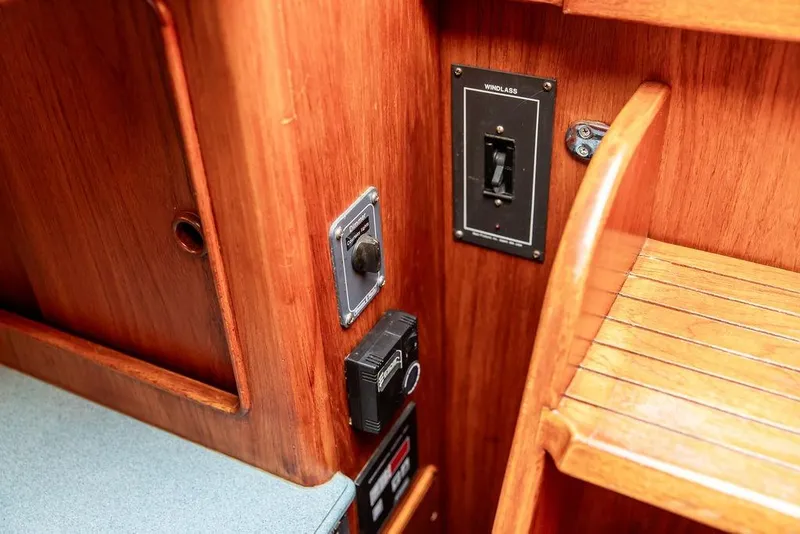 Slide: The Image of 1994 Little Harbor Express interior with wooden paneling and control switches. - 38