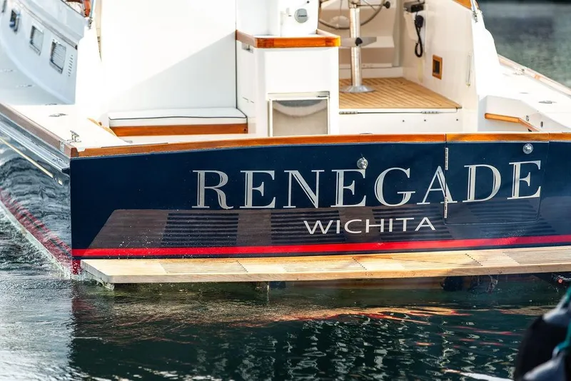 Slide: The Image of 1994 Little Harbor Express boat named "Renegade" docked, featuring elegant wood accents. - 42