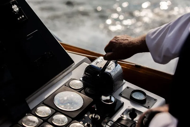 Slide: The Image of Close-up of a hand operating the controls of a 1994 Little Harbor Express boat. - 44