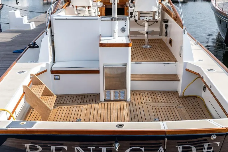 Slide: The Image of 1994 Little Harbor Express boat with teak deck and seating area at a marina. - 48