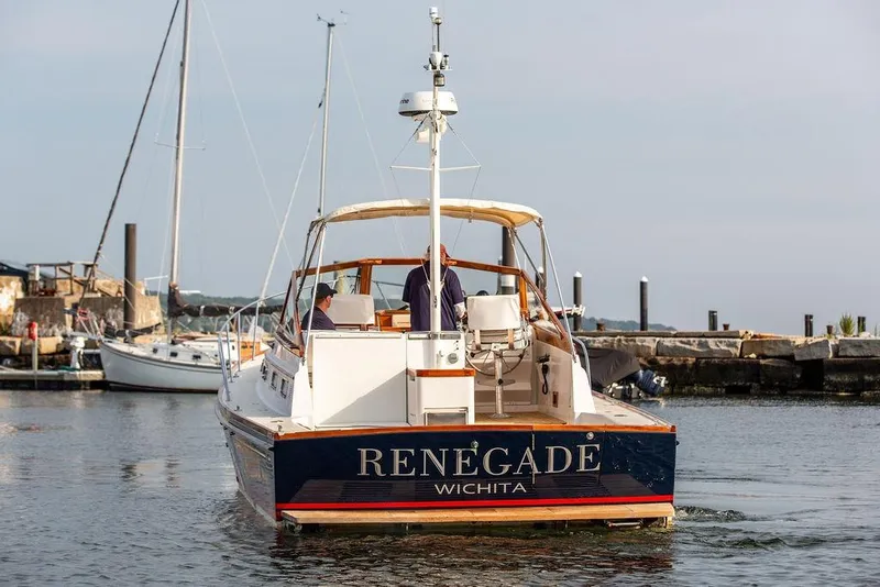 Slide: The Image of 1994 Little Harbor Express boat "Renegade" docked in a marina. - 58