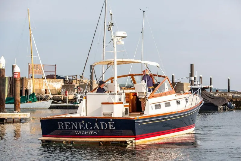 Slide: The Image of 1994 Little Harbor Express boat "Renegade" docked in a marina. - 59