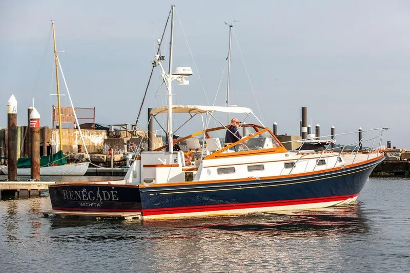 Slide: The Image of 1994 Little Harbor Express boat named "Renegade" docked in a marina. - 61