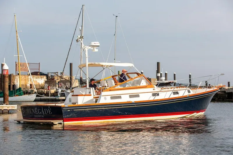 Slide: The Image of 1994 Little Harbor Express yacht docked at a marina, featuring a sleek design and vibrant colors. - 62