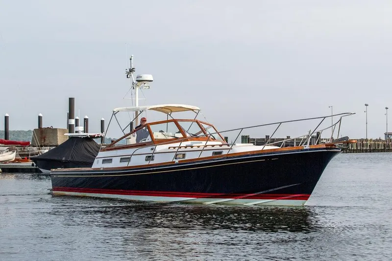 Slide: The Image of 1994 Little Harbor Express yacht cruising in a marina, featuring classic design and sleek lines. - 65