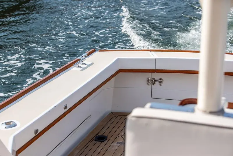 Slide: The Image of 1994 Little Harbor Express boat deck with teak accents on water. - 74