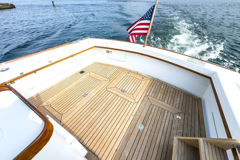 Slide: The Image of 1994 Little Harbor Express boat deck with American flag, cruising on open water. - 8