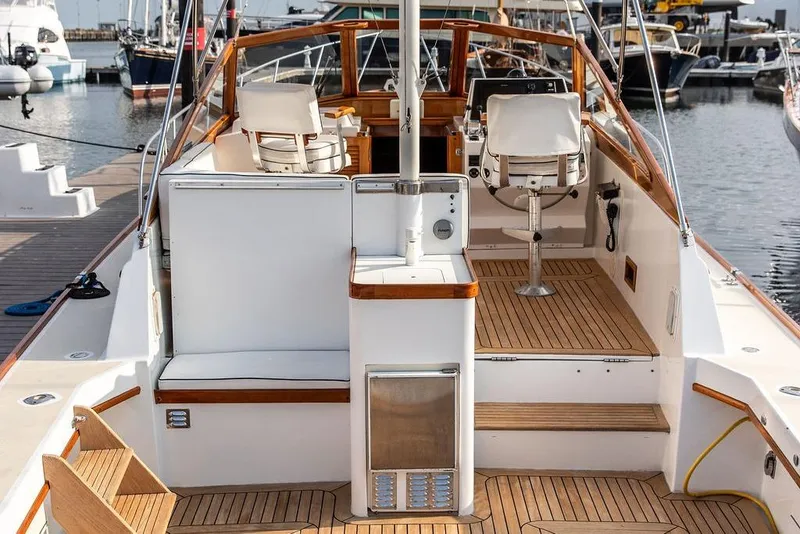 Slide: The Image of 1994 Little Harbor Express yacht interior with wooden deck and seating at marina. - 9