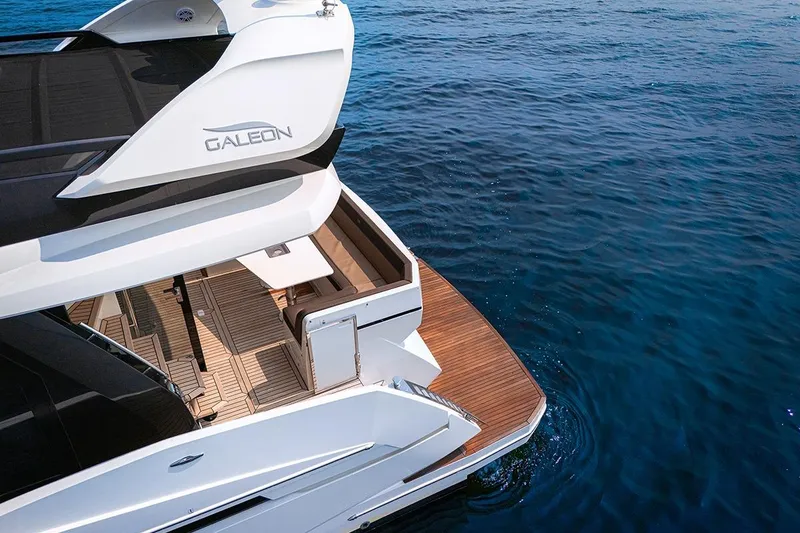 Slide: The Image of 2023 Galeon 470 Sky yacht on serene blue water, showcasing elegant deck design. - 11