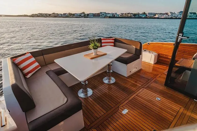 Slide: The Image of Luxurious 2023 Galeon 470 Sky yacht deck with elegant seating and scenic water view. - 13