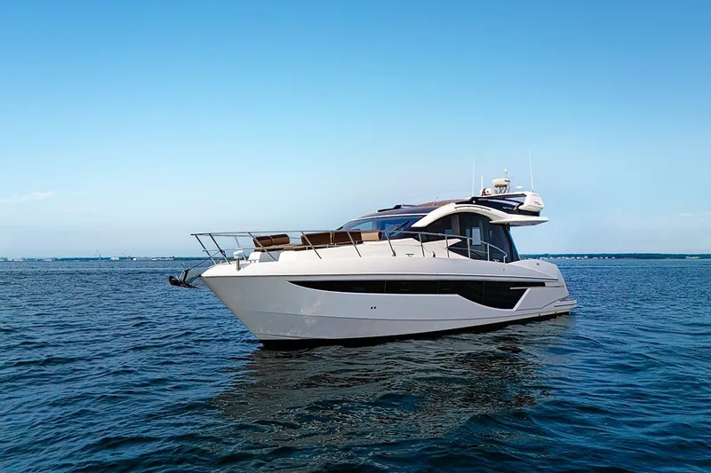 Slide: The Image of 2023 Galeon 470 Sky yacht cruising on open water under clear blue skies. - 21