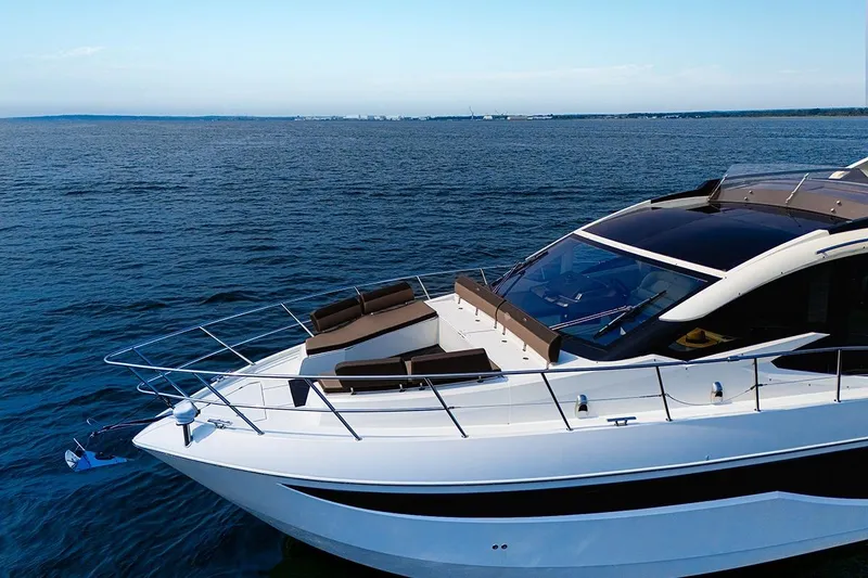 Slide: The Image of 2023 Galeon 470 Sky yacht cruising on open water under clear skies. - 22