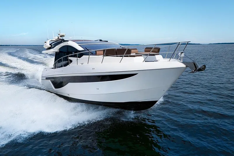 Slide: The Image of 2023 Galeon 470 Sky yacht cruising on open water under clear blue skies. - 25