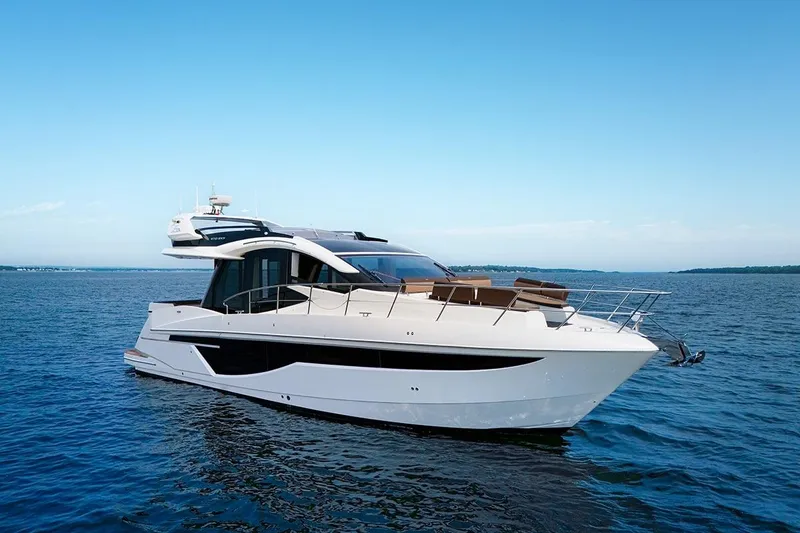 Slide: The Image of 2023 Galeon 470 Sky yacht cruising on open water under clear blue skies. - 4